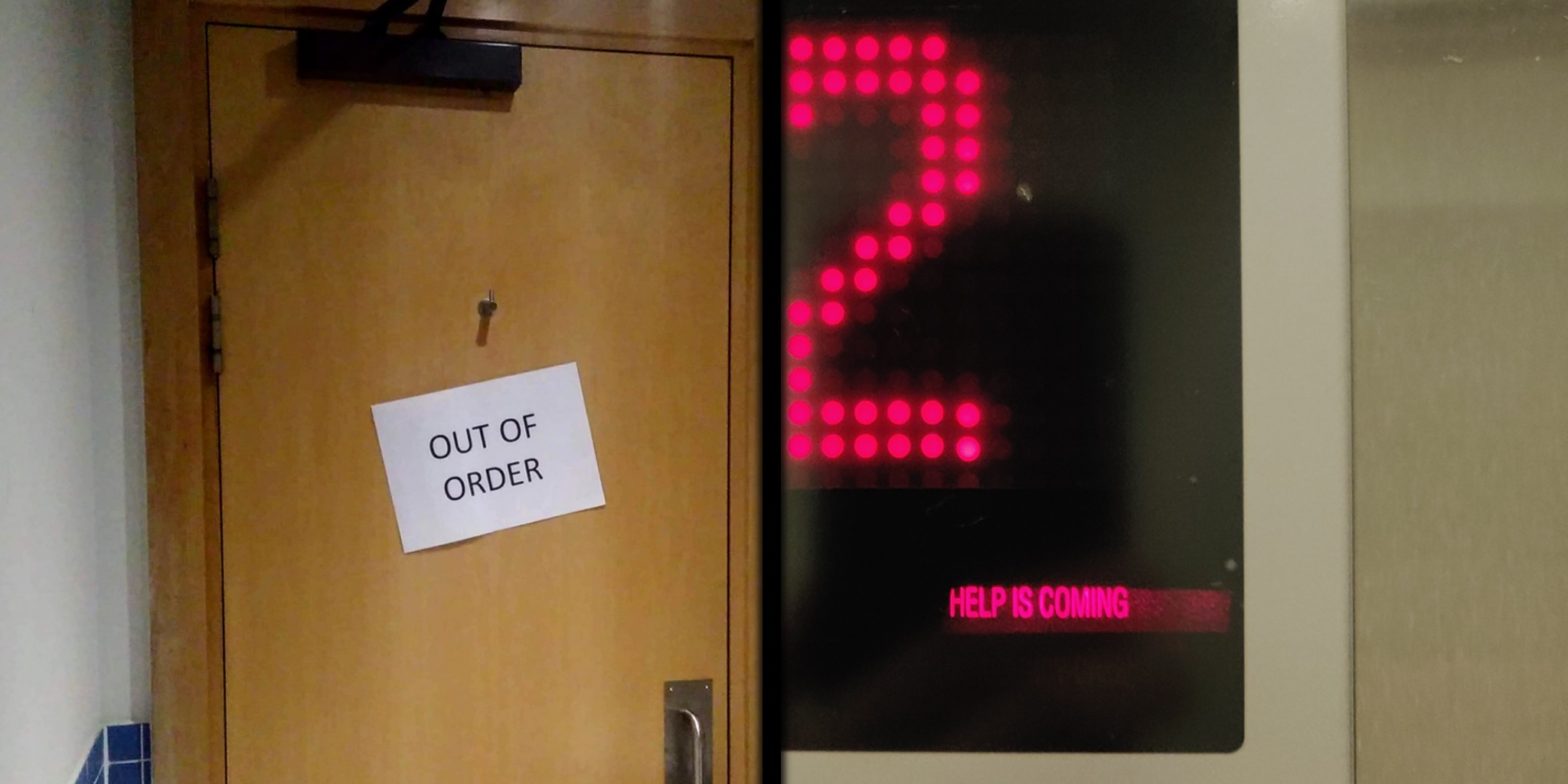 Inside of a toilet door with sign "Out of Order" and lift display stating "Help is Coming".